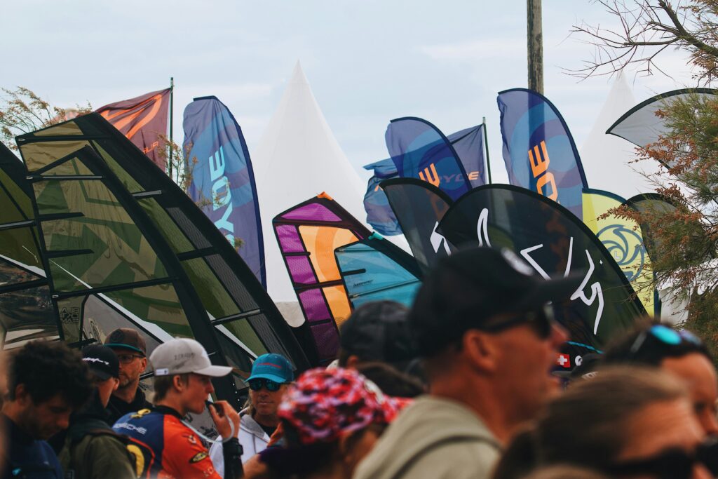 Crowd of people standing together with feather flags