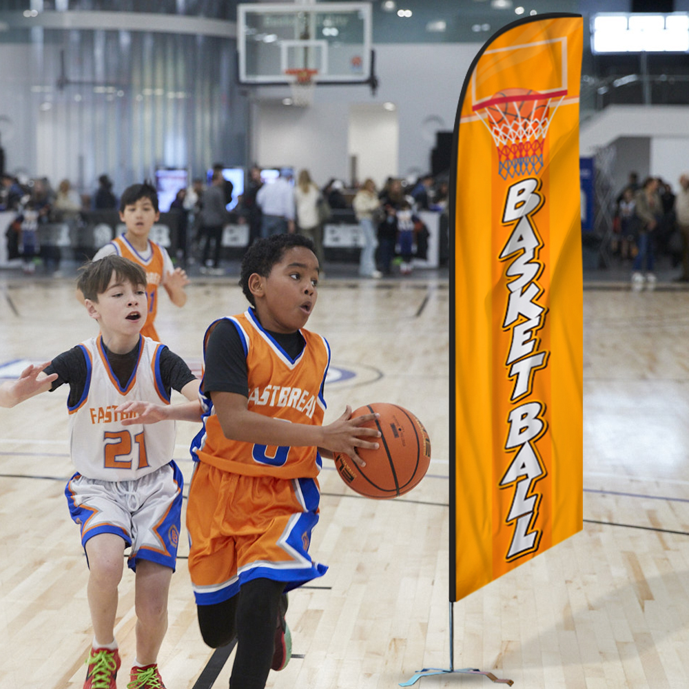 Basketball feather flag set up at a youth game with kids playing in front of a crowd