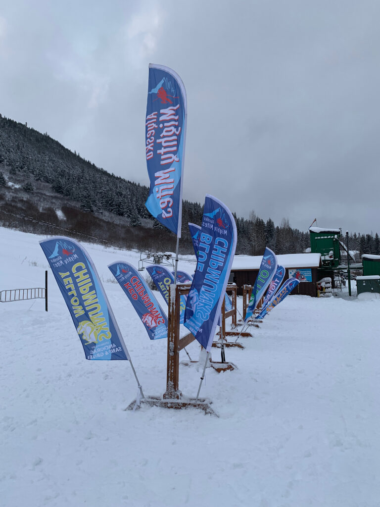 Feather flags lined up at a ski resort