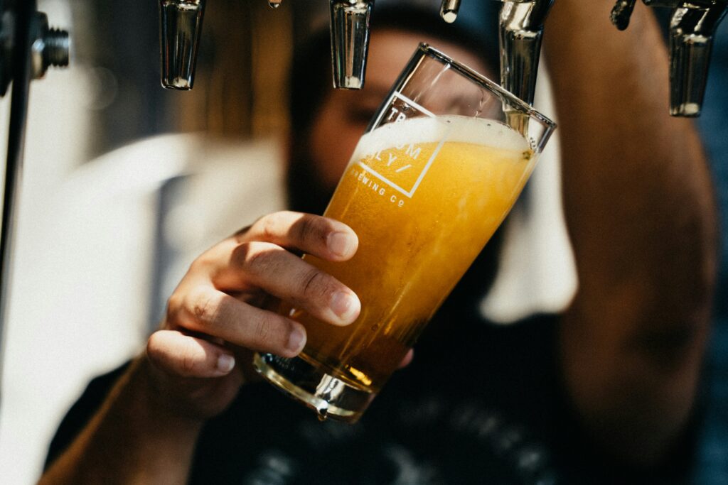 Person pouring beer from a tap