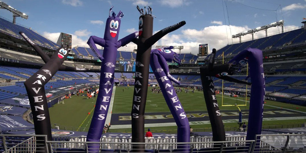 Why you should be using Tube Men to Advertise 5 purple tube men at sports game