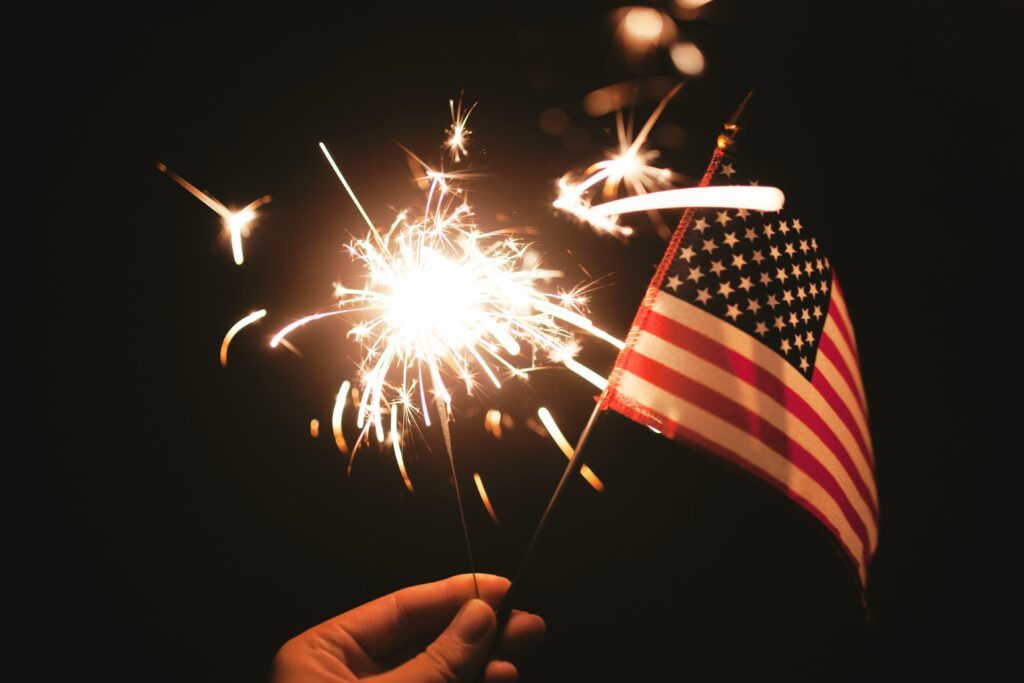 Sparkler and 4th of July flag