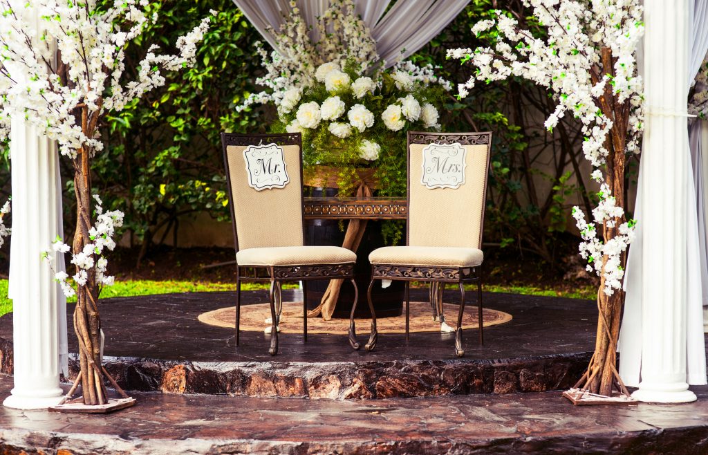 two black chairs and table at wedding