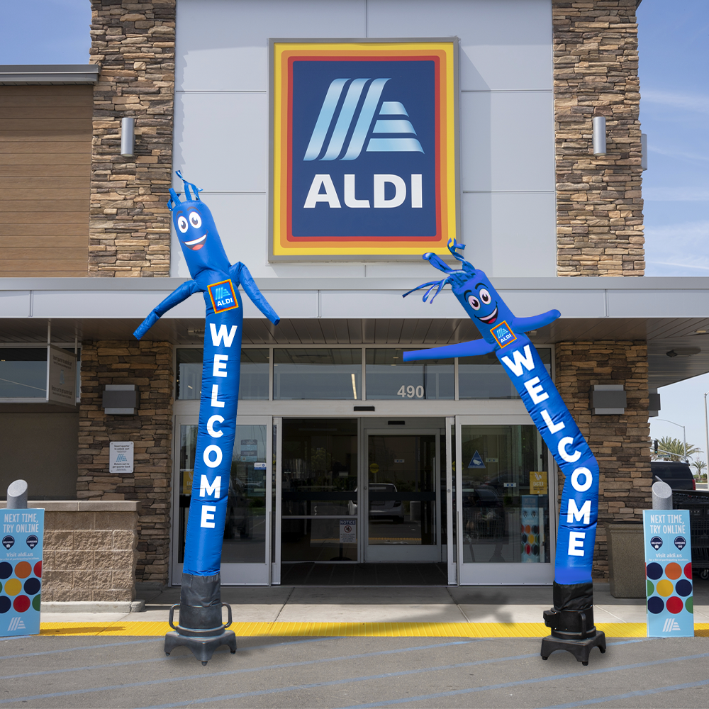 Two blue tube men in front of an Aldi