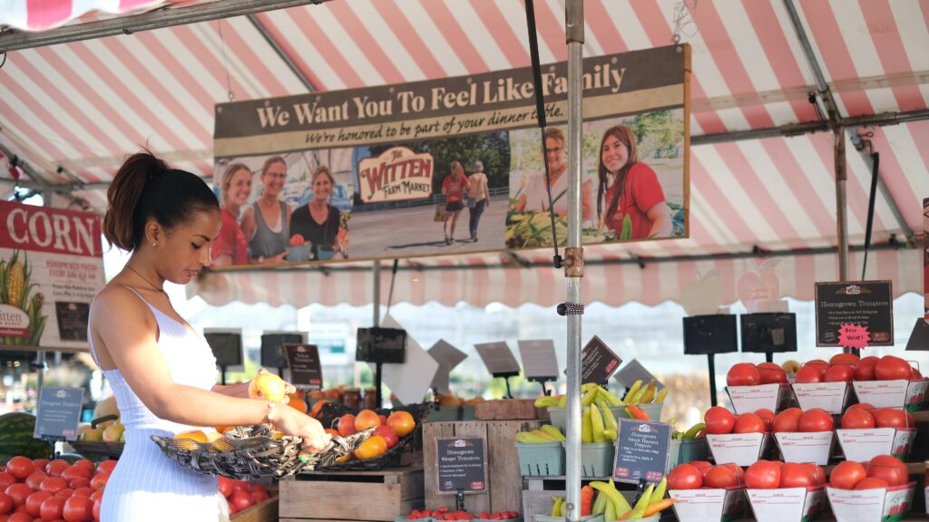 Woman standing in front of fruit stand