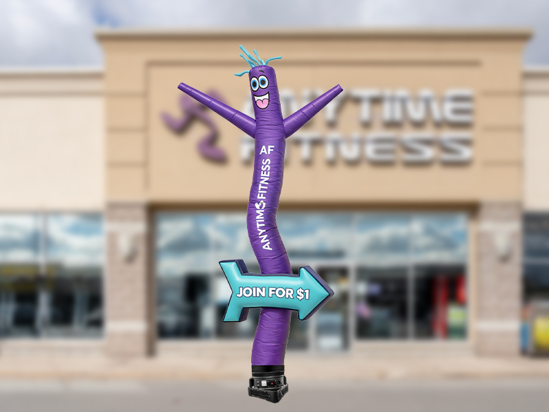 Custom arrow inflatable tube man standing approximately 20ft tall on blower for directional advertising and roadside promotions